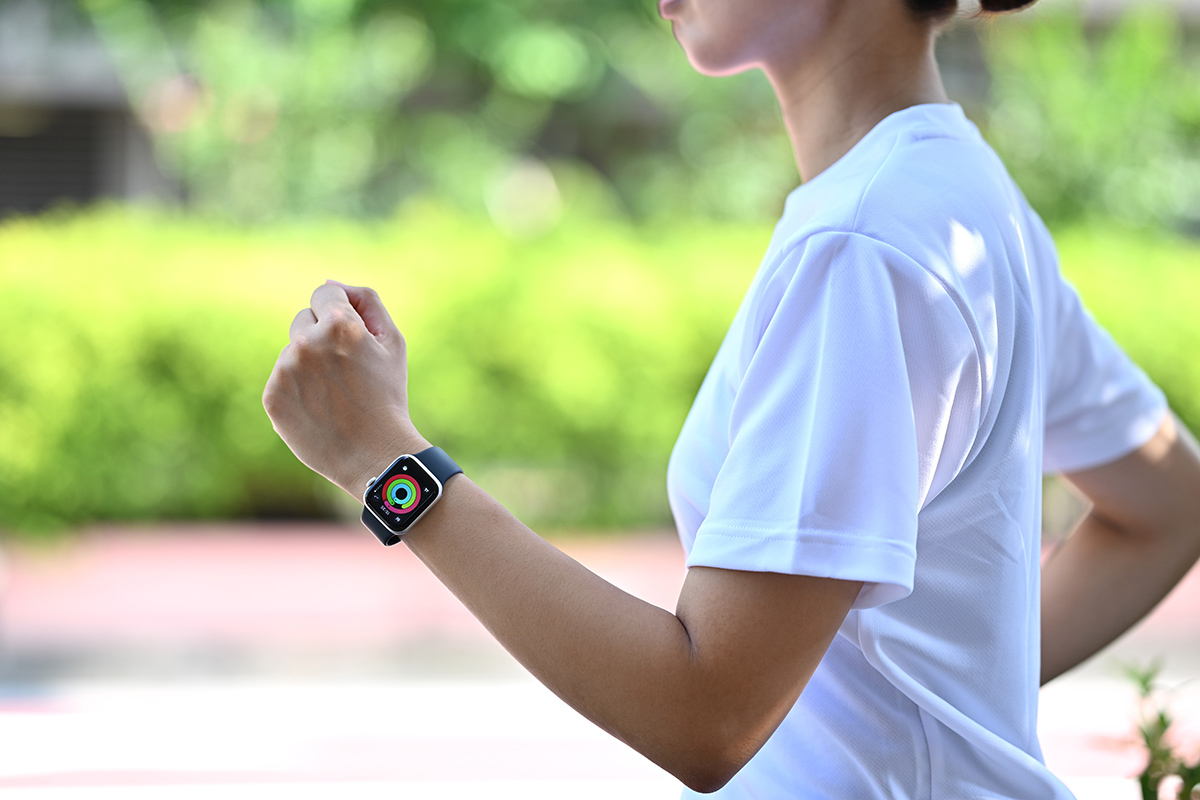 A photo of a person running while wearing an Apple Watch.